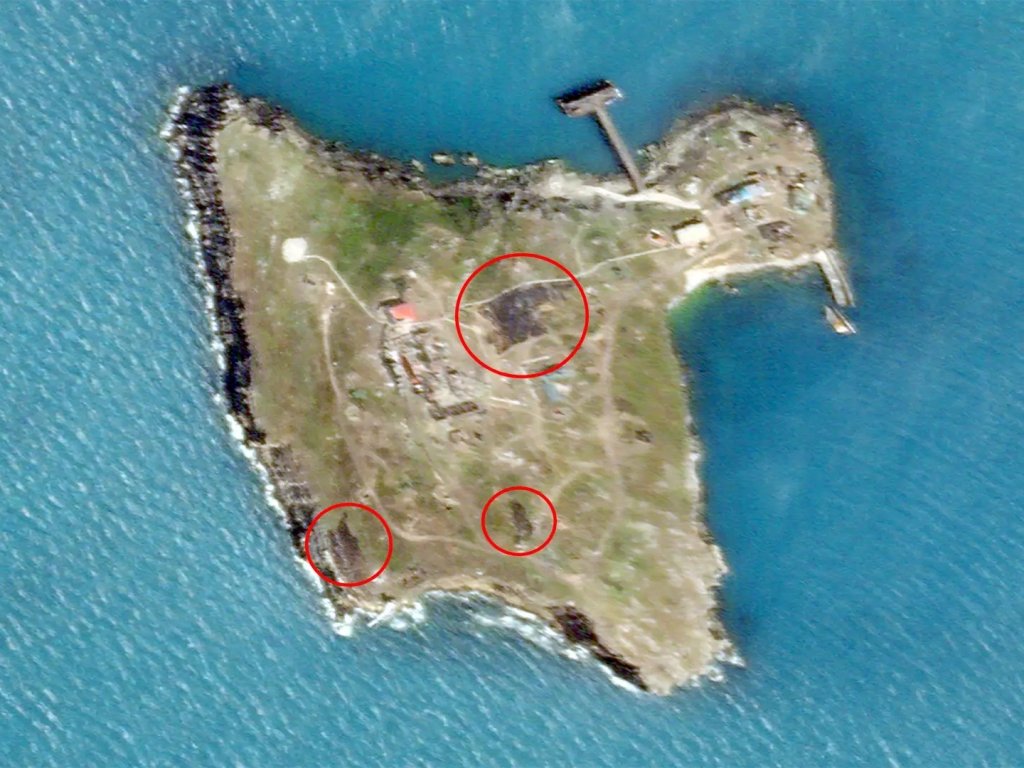 Satellite image of Snake Island, taken on June 21, 2022 with dark spots indicating explosions or fires